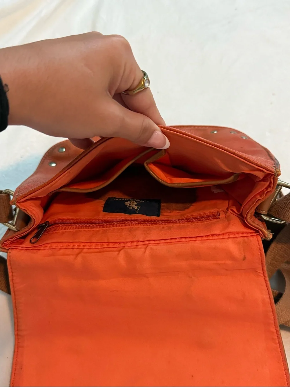 Orange U.S. Polo Assn. leather crossbody bag with brown strap